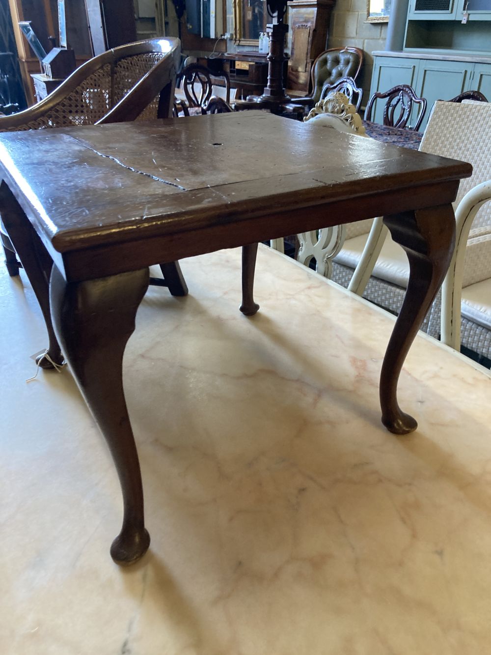 A childs caned mahogany bergere on table stand